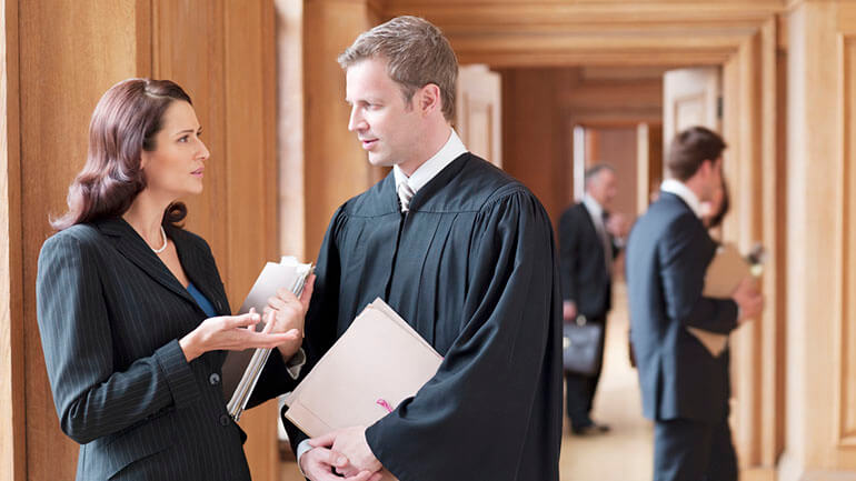 legal wigs in modern courtrooms - barristers talking