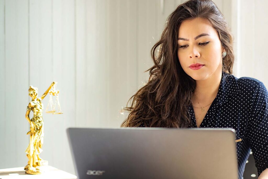 woman at the desk working on a laptop