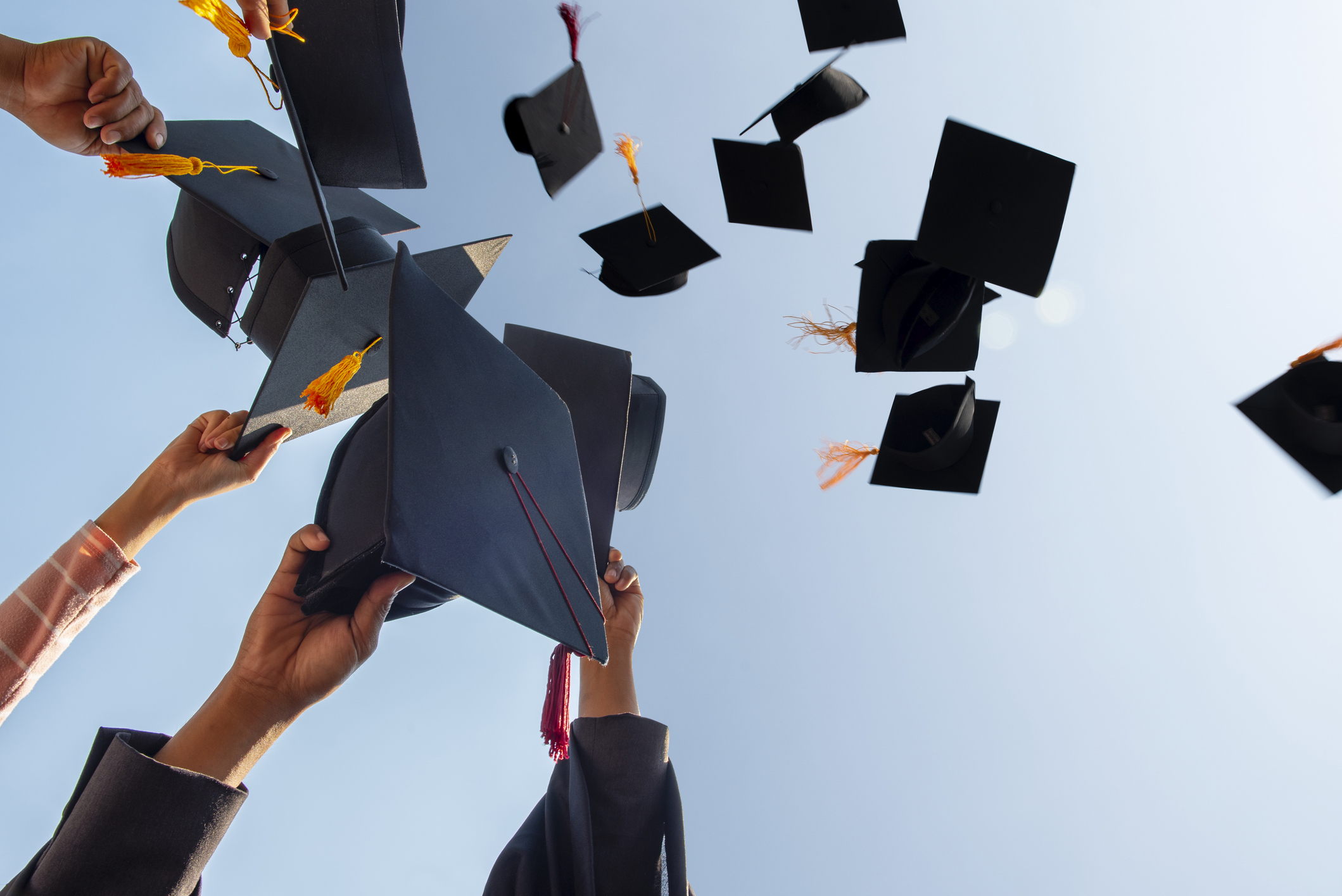 Black hat of the graduates floating in the sky.