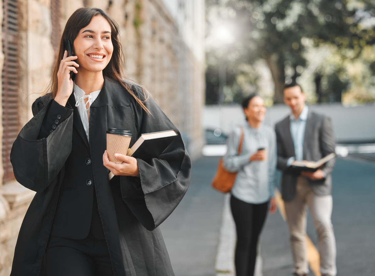 Lawyer, woman and phone call with smile in city for law, justice or human rights with advice for job at court. Attorney, advocate and person with book, contact or documentation for evidence in street