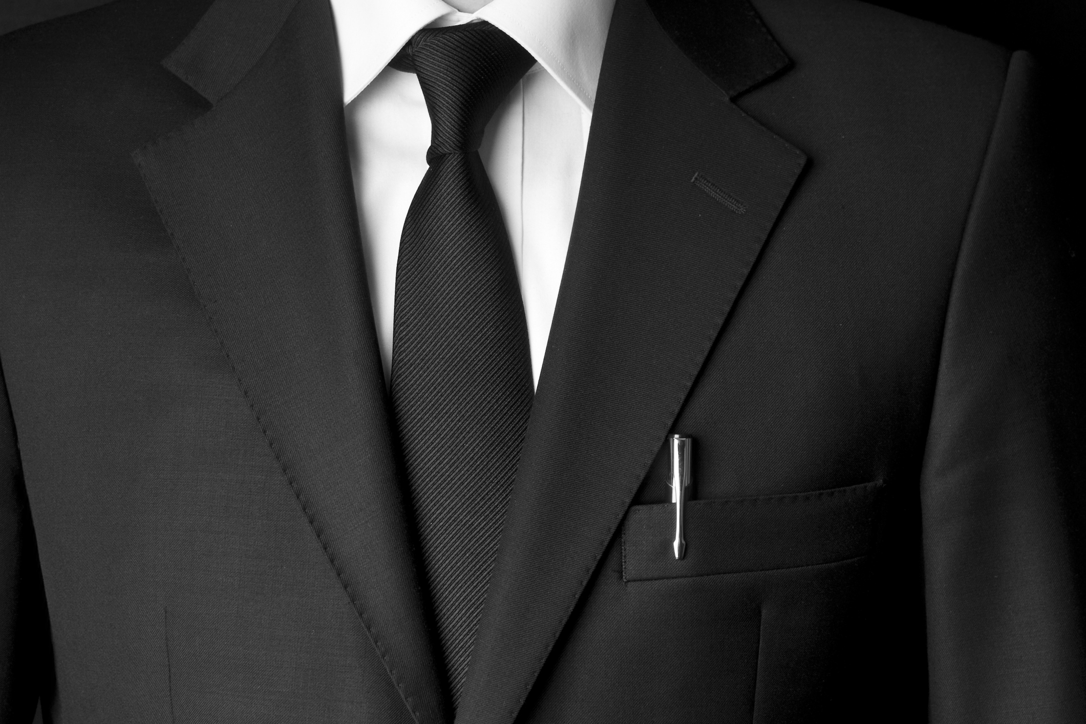 Close up of classic business attire with power tie and black blazer.